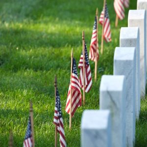 american-flags-in-front-of-tombstones-at-AHRQ7GY