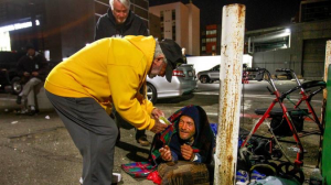 Passing out sleeping bags to homeless